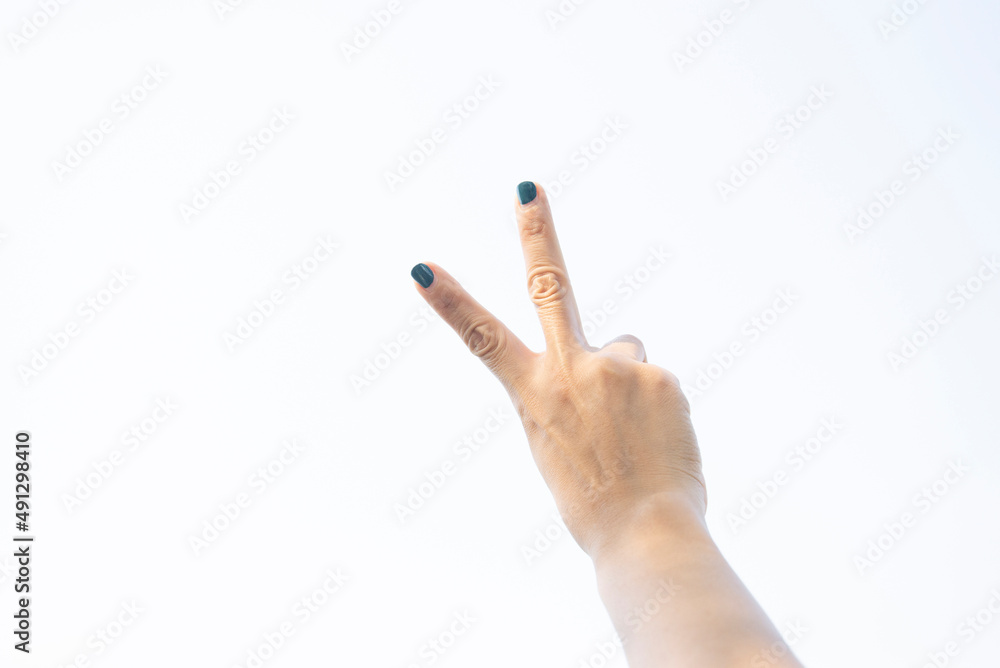 Hands and fingers of a woman showing symbolic gestures.