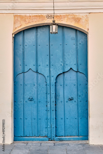 Photography External blue wooden gates with two doors in building in old colonial city of Trinidad, Cuba