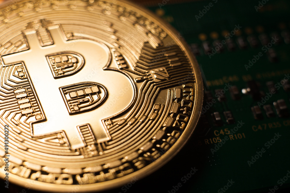 Bitcoin coin on green circuit background. Cryptocurrency, virtual money. Blockchain technology, bitcoin mining concept.