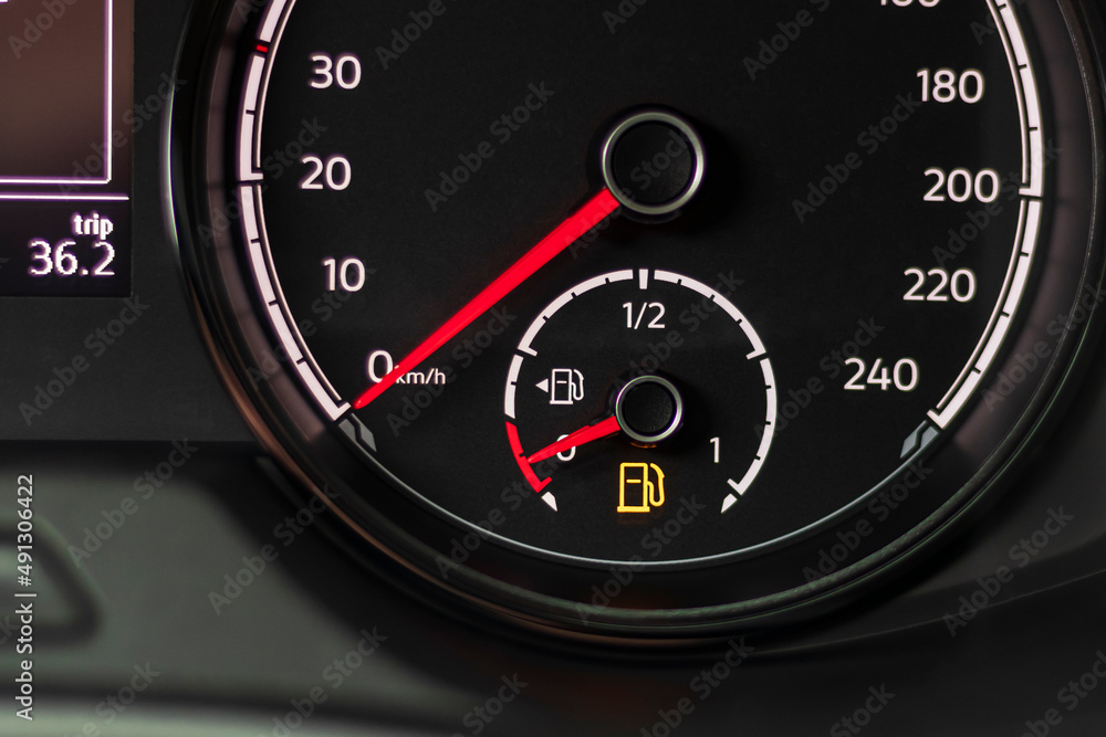 Fuel discharge warning light on the dashboard of the car. The low fuel level is displayed on the dashboard of the speedometer. Fuel discharge warning light on the dashboard of the car. The low fuel level is displayed on the dashboard of the speedometer.
