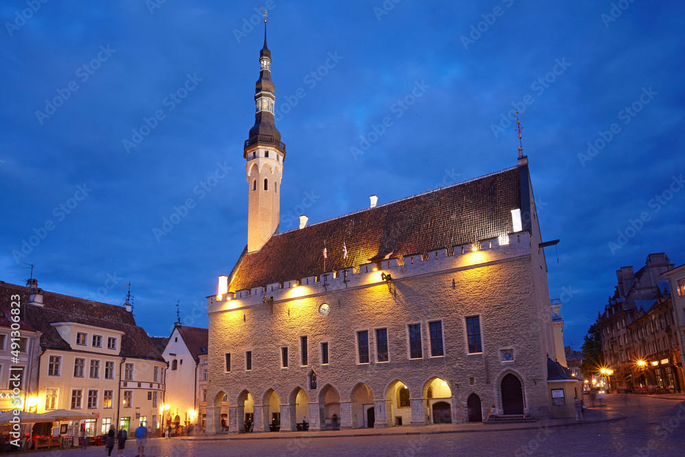 The Town Hall of Tallinn illuminated at dusk, this gothic style building dates from 1402-04