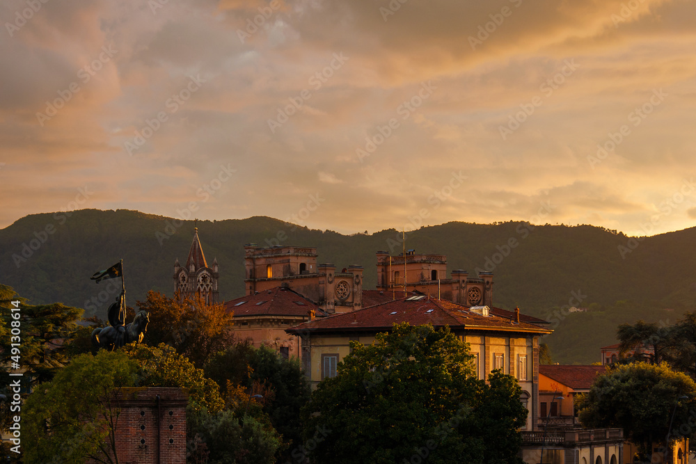 Beautiful sunset sky over Lucca historical center old buildings