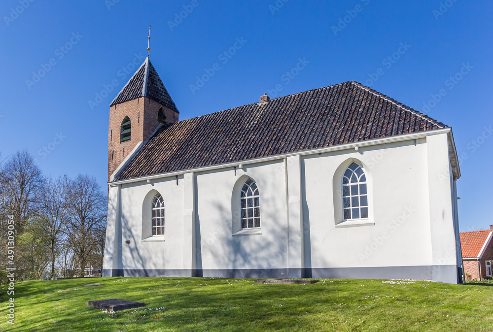 Little white church in historic village Mensingeweer, Netherlands
