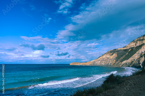 High cliff by the ocean, beautiful ocean view, beautiful sky with white clouds
