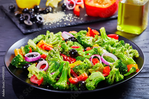 Broccoli salad with paprika, sesame seeds, olives