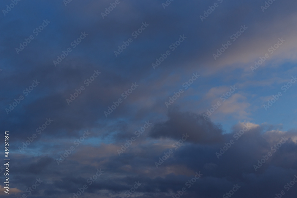 A dark blue autumn sky with thunderclouds and white clouds. Ready for use with «Sky Replacement» feature in the Adobe Photoshop.	