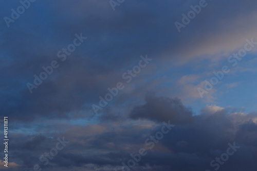 A dark blue autumn sky with thunderclouds and white clouds. Ready for use with «Sky Replacement» feature in the Adobe Photoshop. 