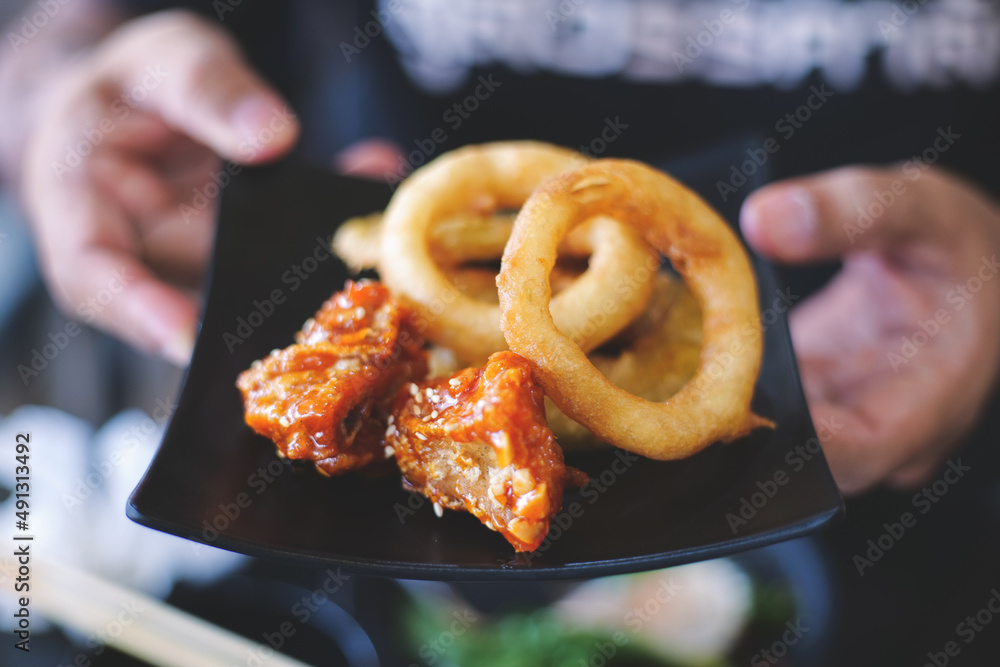 The Crunchy Fried Onion Rings with Korean Fried Chicken. Stock Photo