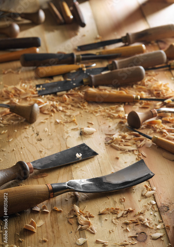 Carving wood with chisel. Carpenter's hands use chiesel photo