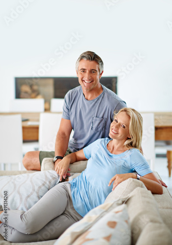 We live a contented life. Portrait of a loving mature couple relaxing at home.