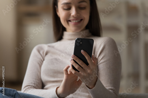Happy woman use smartphone, close up focus on device. Modern wireless tech usage, young gen use e-date services, buy goods and e-services on-line, spend leisure on internet, social media user concept