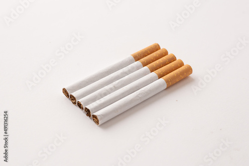blonde cigarettes with filter on a white table, white background