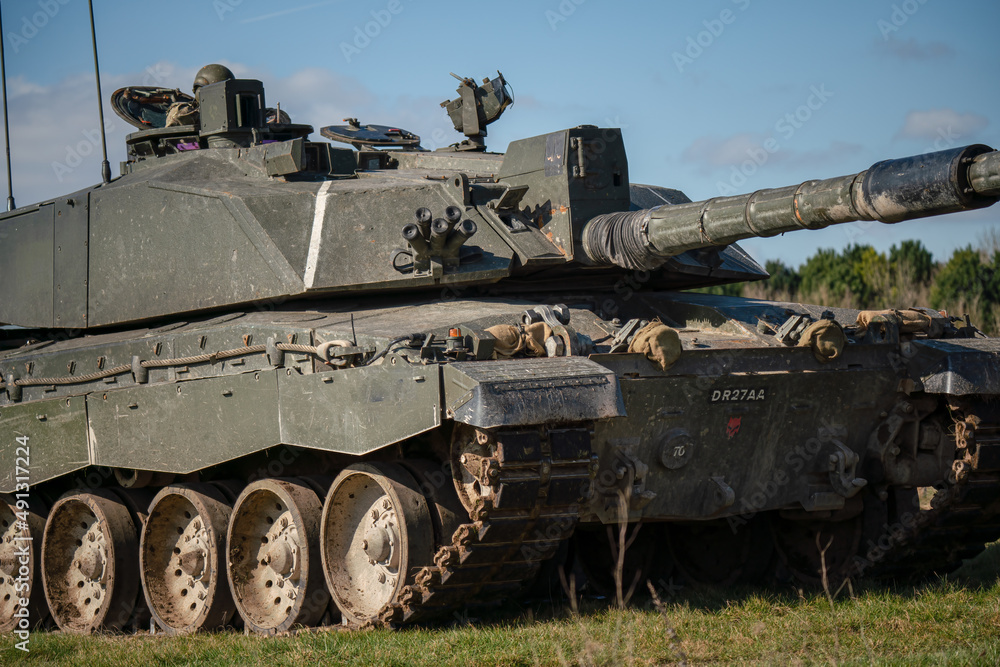 army battle tank gun barrel raised and locked on target