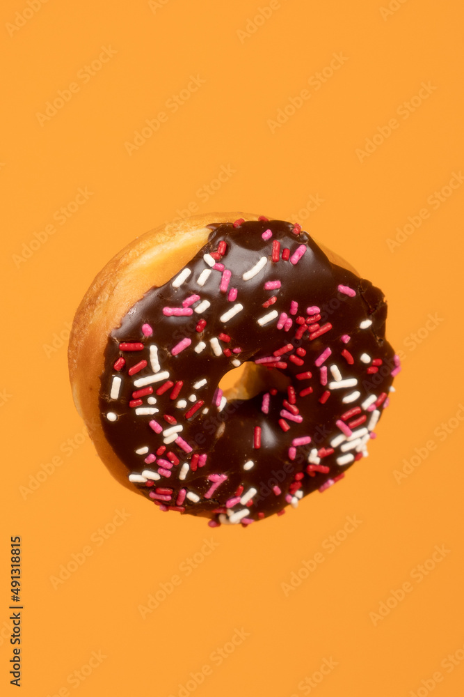 Chocolate frosted donut with Sprinkles Chocolate frosted donut with Sprinkles