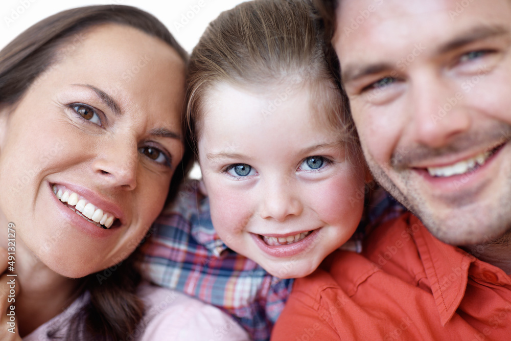 Smiling runs in the family. Close-up portrait of a young family. Smiling runs in the family. Close-up portrait of a young family.