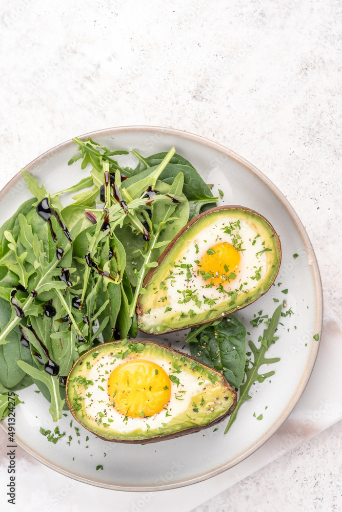 Healthy breakfast. Avocado stuffed with eggs on the table Healthy breakfast. Avocado stuffed with eggs on the table