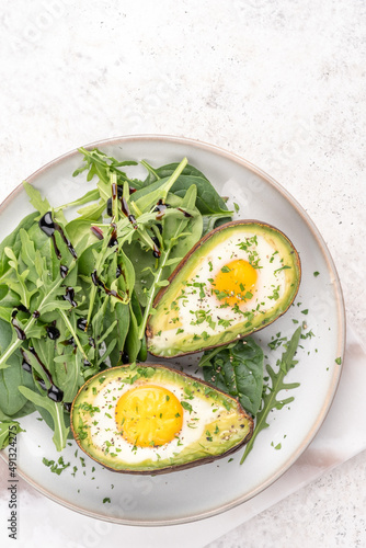 Healthy breakfast. Avocado stuffed with eggs on the table