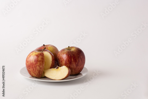 ripe red apples on a plate, white background
