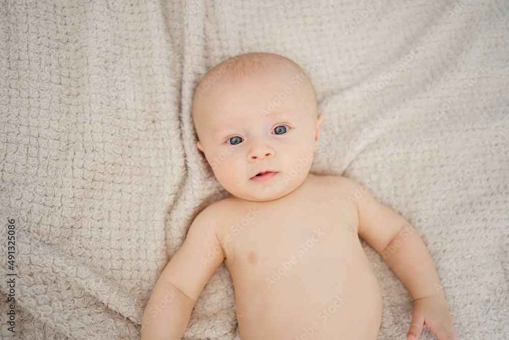 top view. Funny and beautiful baby on the bed. children's health. top view. Funny and beautiful baby on the bed. children's health.