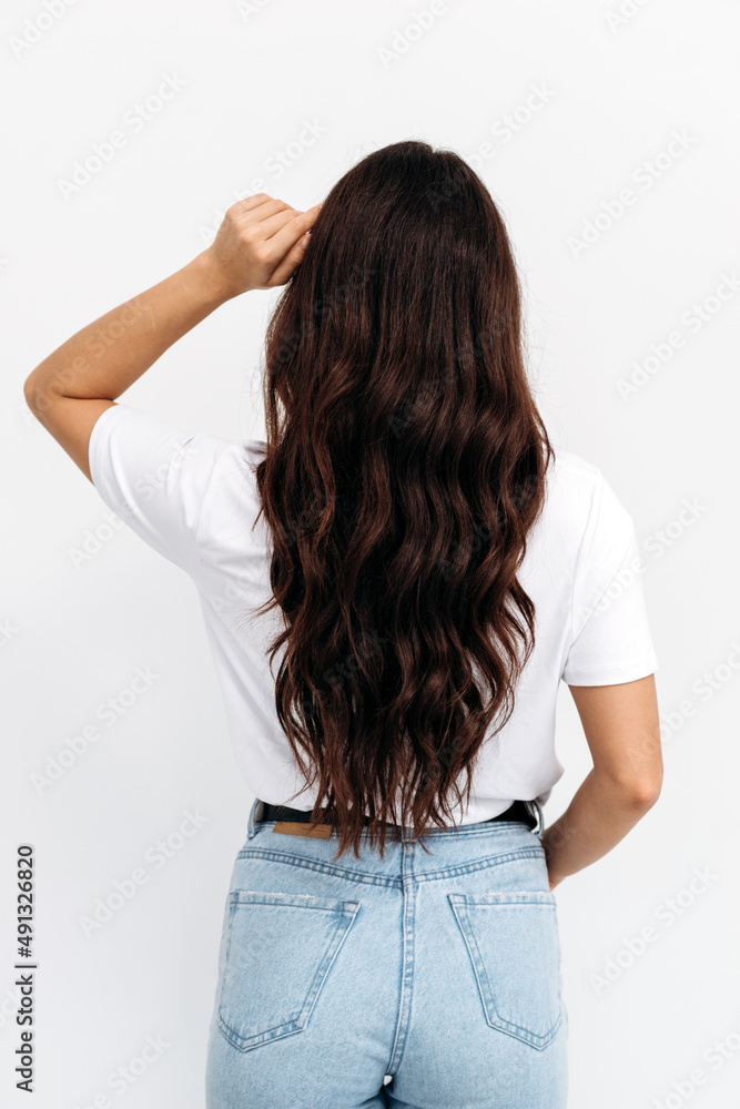 Woman from backside on white background. Female with curly hair Woman from backside on white background. Female with curly hair