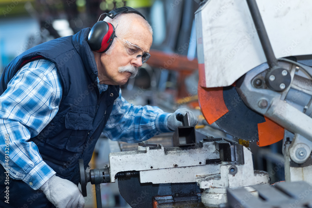 portrait of a worker cutting steel bar