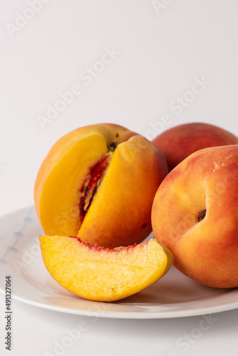 ripe peaches on a plate, white background