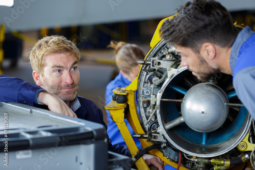 apprentices aeronautical engineers learning with their professor photo