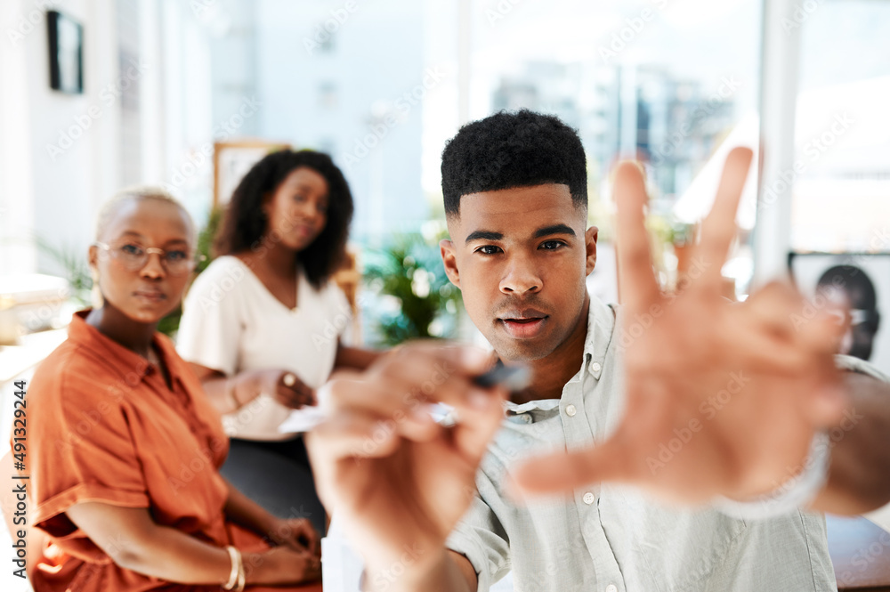 Focused on making big plans work. POV shot of a young businessman holding a marker while giving a presentation in an office. Focused on making big plans work. POV shot of a young businessman holding a marker while giving a presentation in an office.