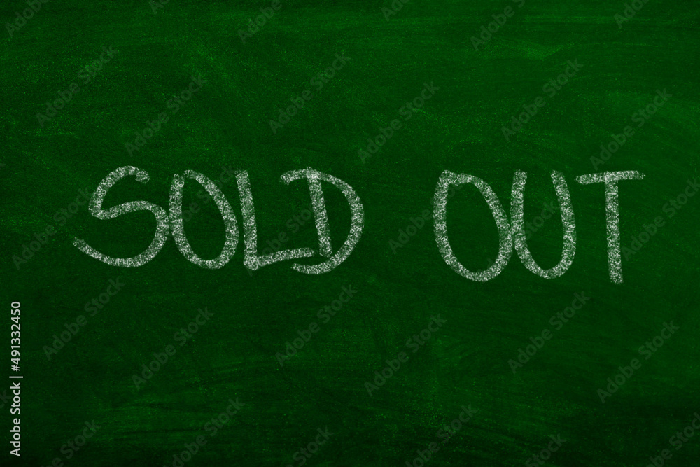 Sold out sign on chalkboard hand-written with chalk Sold out sign on chalkboard hand-written with chalk