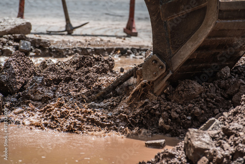 Принти на полотні bulldozer shovel lifting debris strewn over the street