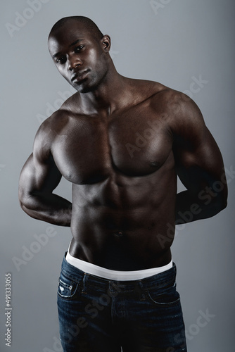 Hes solid. A handsome and muscular young man posing in the studio.