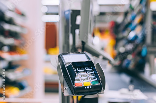 Cash machine. On the background of showcases of supermarket showcases.