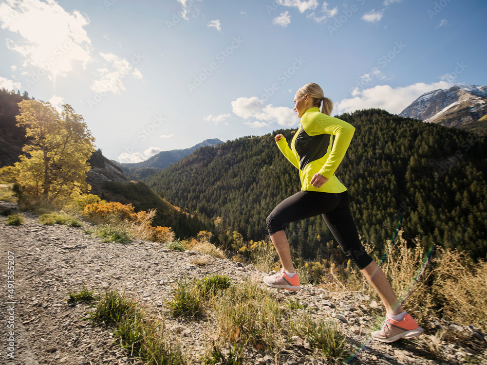 United States, Utah, American Fork, Woman jogging in mountain landscape United States, Utah, American Fork, Woman jogging in mountain landscape
