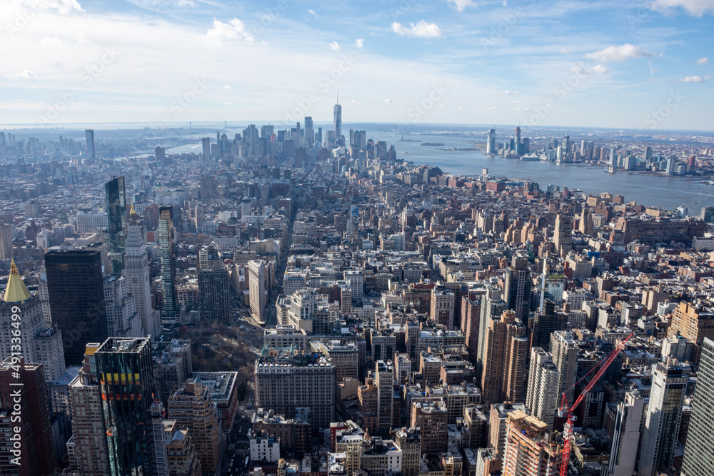 Aerial panoramic view of midtown Manhattan in New York with skyscrapers and blue sky.