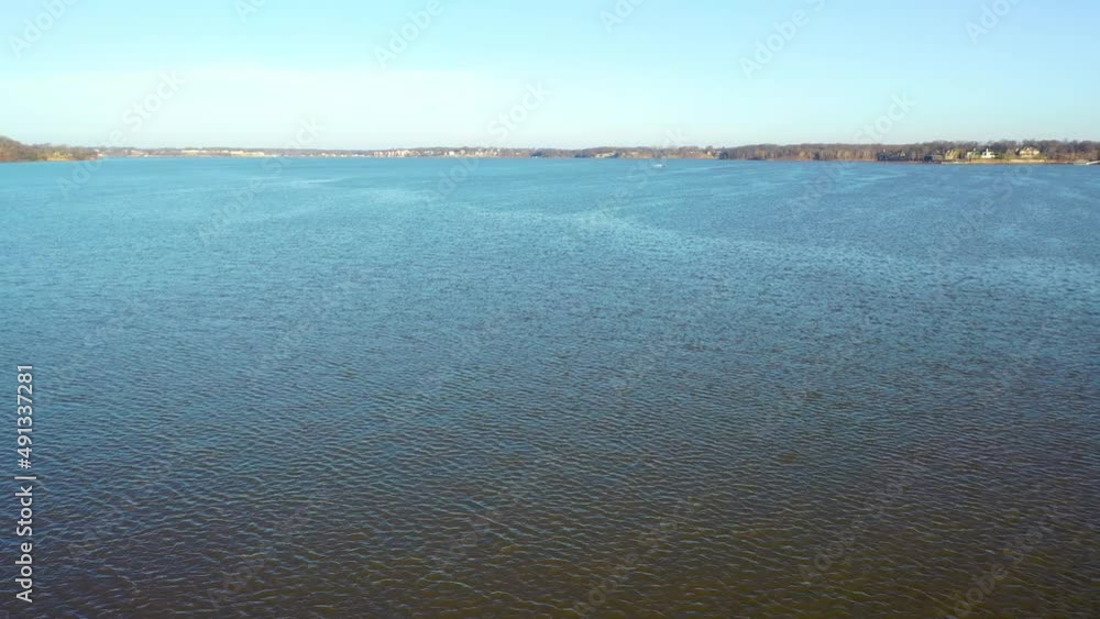 Calm Blue Waters Of Table Rock Lake in Midwest Branson Missouri With Boat Driving in Background. aerial drone pullback Calm Blue Waters Of Table Rock Lake in Midwest Branson Missouri With Boat Driving in Background. aerial drone pullback