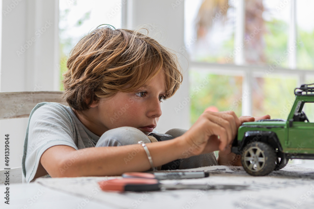 Boy (8-9) building car model toy Boy (8-9) building car model toy