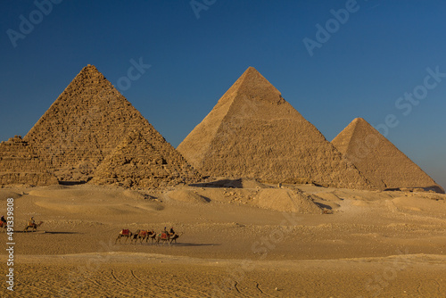 CAIRO, EGYPT - JANUARY 28, 2019: Camel riders in front of the Great pyramids of Giza, Egypt