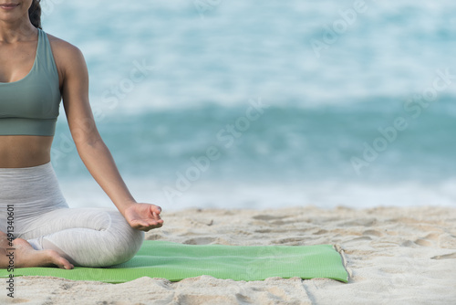 woman doing exercise. woman doing yoga. woman doing exercise on beach.