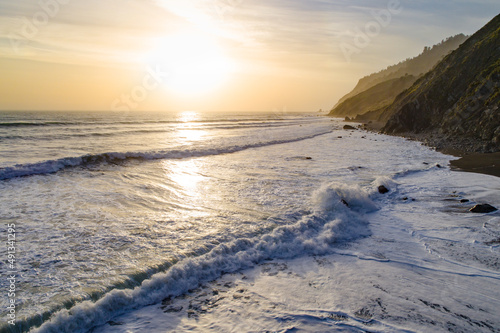 Waves crash on the beach at sunset at Usal Creek in the Lost Coast, California