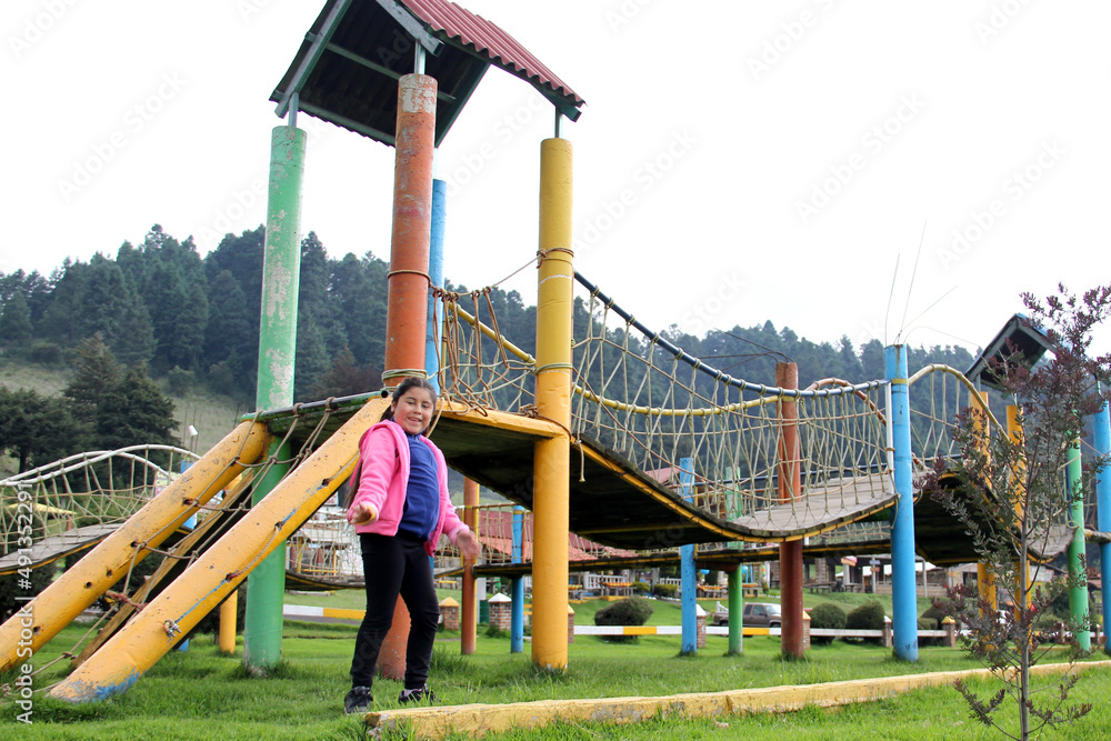 Latin little girl with long straight black hair, overweight body positive and does sports playing in the playground in the middle of the forest and mountains with trees
Latin little girl with long straight black hair, overweight body positive and does sports playing in the playground in the middle of the forest and mountains with trees