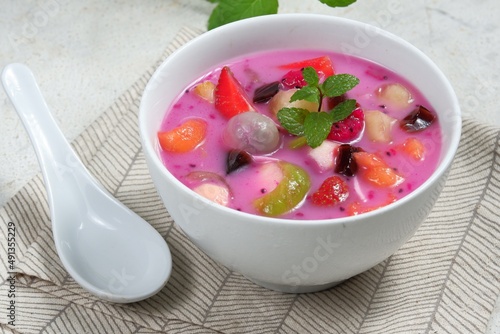 Es buah or sop buah-is an Indonesian iced fruit cocktail dessert. This cold and sweet beverage is made of diced fruits mixed with shaved ice or ice cubes, and sweetened with liquid sugar or syrup. photo