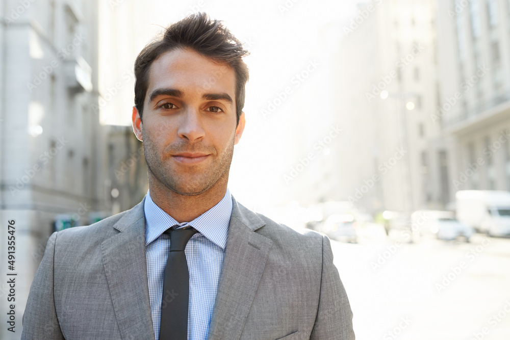 The modern businessman. Shot of a well-dressed young businessman in the city. The modern businessman. Shot of a well-dressed young businessman in the city.