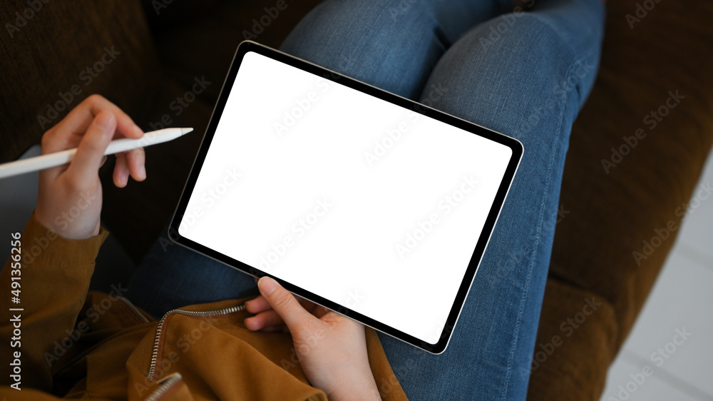 Relaxed young female using digital tablet touchpad on sofa at home. Relaxed young female using digital tablet touchpad on sofa at home.