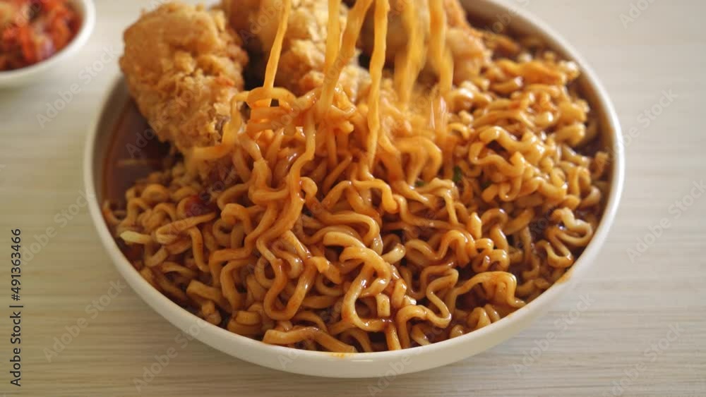 Korean instant noodles with fried chicken or Fried chicken ramyeon - Korean food style Korean instant noodles with fried chicken or Fried chicken ramyeon - Korean food style