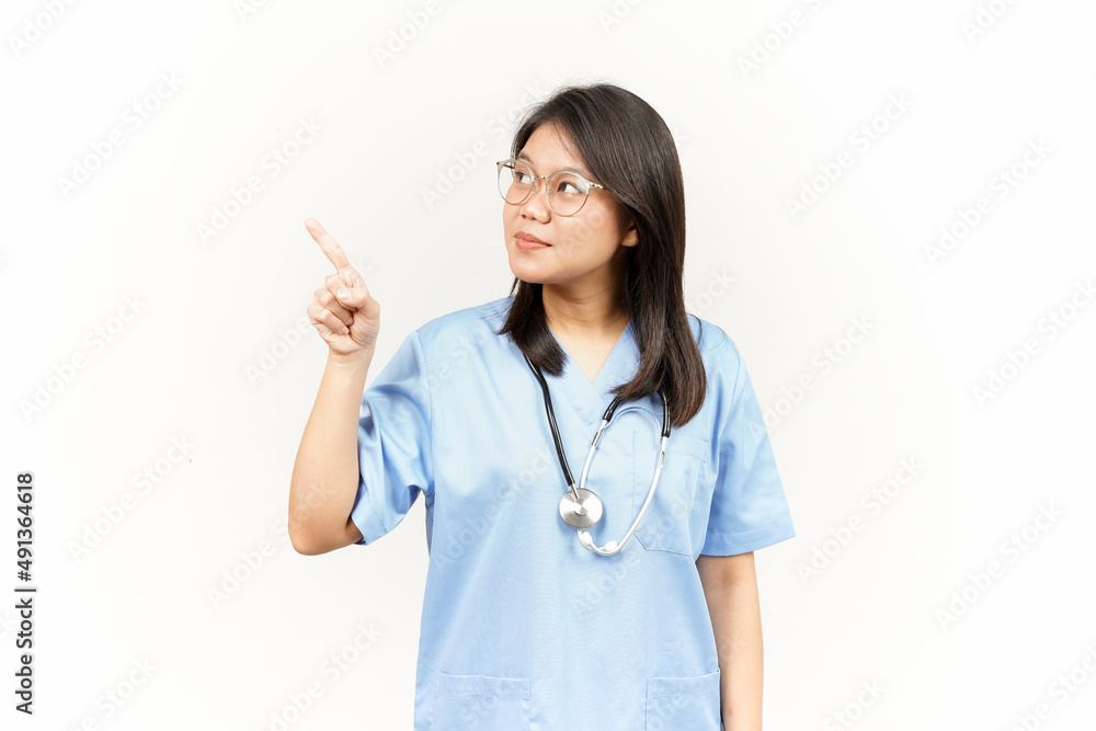 Showing Product and Pointing Side Of Asian Young Doctor Isolated On White Background Showing Product and Pointing Side Of Asian Young Doctor Isolated On White Background