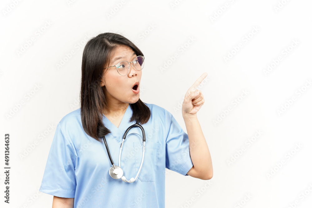 Showing Product and Pointing Side Of Asian Young Doctor Isolated On White Background Showing Product and Pointing Side Of Asian Young Doctor Isolated On White Background