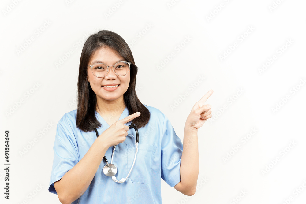 Showing Product and Pointing Side Of Asian Young Doctor Isolated On White Background Showing Product and Pointing Side Of Asian Young Doctor Isolated On White Background