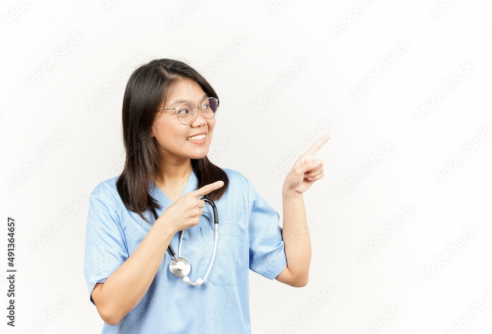 Showing Product and Pointing Side Of Asian Young Doctor Isolated On White Background Showing Product and Pointing Side Of Asian Young Doctor Isolated On White Background