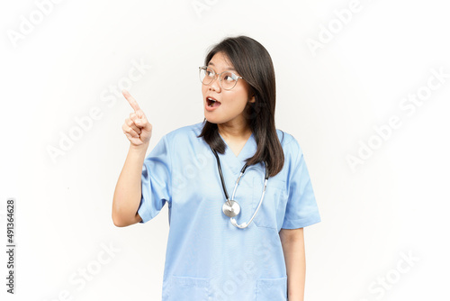 Showing Product and Pointing Side Of Asian Young Doctor Isolated On White Background