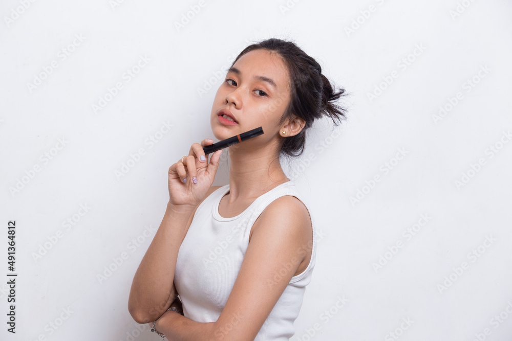 beautiful young asian woman using lipstick isolated on white background
beautiful young asian woman using lipstick isolated on white background